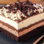 Triple chocolate mousse cake slice with three chocolate layers